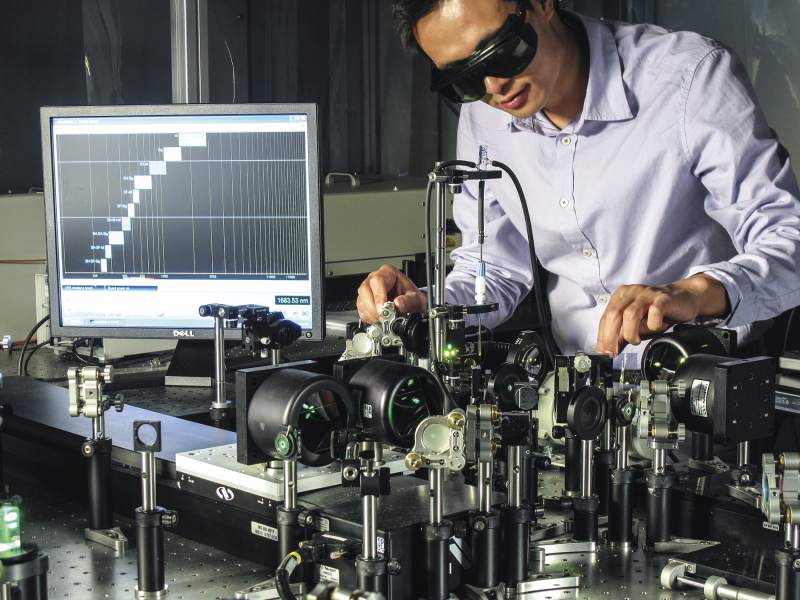 A scientist adjusts a laser experiment